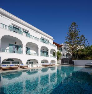 a swimming pool in front of a building at Armonia in Kamari