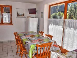 a kitchen with a table and chairs and a refrigerator at Appartement Morzine, 2 pièces, 6 personnes - FR-1-524-19 in Morzine