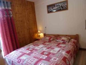 - une chambre avec un lit et une couette rouge dans l'établissement Appartement Morzine, 2 pièces, 6 personnes - FR-1-524-20, à Morzine