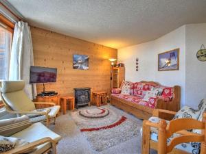 a living room with a couch and a fireplace at Appartement 3 pièces rénové, pieds des pistes et proche centre, Morzine - FR-1-524-35 in Morzine