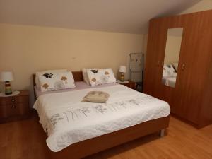 a bedroom with a bed with white sheets and pillows at LEVANDA in Supetarska Draga