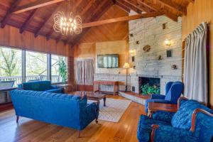ein Wohnzimmer mit blauen Sofas und einem Kamin in der Unterkunft Ledge Lodge Burkesville Getaway Pool and Views! in Burkesville