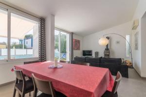 a dining room with a red table and chairs at Son serra de marina - 27077 Mallorca in Son Serra de Marina