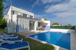 a villa with a swimming pool and lounge chairs at Son serra de marina - 27077 Mallorca in Son Serra de Marina