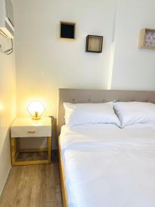 a bedroom with a bed and a nightstand next to a bed sidx sidx sidx at Cozy Condo bedroom in Bacolod City in Bacolod