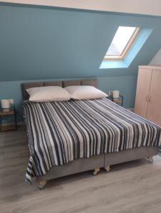 a bedroom with a bed with two pillows and a window at Agroturystyka u Pawła i Asi in Kobyla Góra