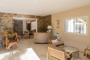 a living room with a table and chairs at Domaine Le Courti - Adult only in Le Barcarès