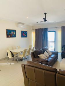 sala de estar con sofá, mesa y sillas en Relax Serviced Ocean 3bedroom Beach Front House en Bijilo
