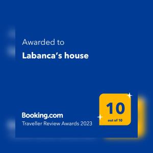 a yellow sign that says awarded to laaderas house at Labanca’s house in Rome