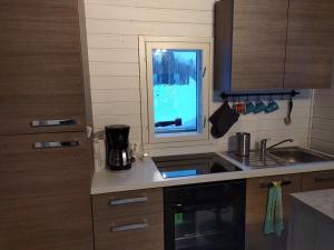 a kitchen with a sink and a window at VillaNorva in Saarenkylä