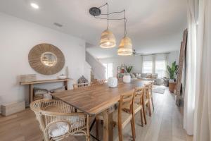 a dining room with a wooden table and chairs at New Construction 1 mile from Downtown Ybor City in Tampa