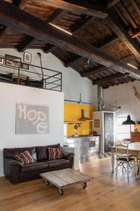 a living room with a couch and a table at Loft nel borgo in Bracciano