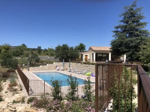a swimming pool in a yard with a fence at Chambre d'hôtes Bambou- A l'Ombre des Tilleuls in Lagorce