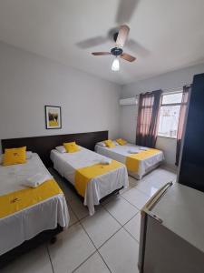 ein Zimmer mit zwei Betten und einem Deckenventilator in der Unterkunft Hotel Panorama, Cuiabá in Cuiabá