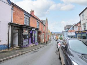 a city street with cars parked on the side of the road at 26 High Street in Bishops Castle