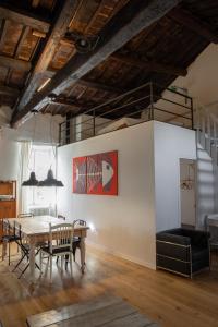 a dining room with a table and chairs at Loft nel borgo in Bracciano