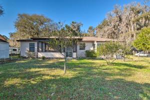 a house with a small tree in the yard at Private Dock Lake Rousseau Retreat! in Dunnellon