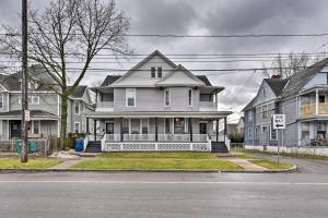 a white house on the corner of a street at Niagara Falls Townhome Near Wineries! in Niagara Falls