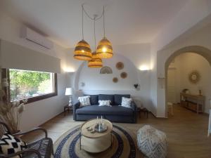 a living room with a blue couch and a table at Patmos Little Suites in Skala