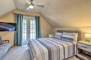 a bedroom with a bed and a window at Lakefront Linn Creek Home with Dock and Slip! in Linn Creek