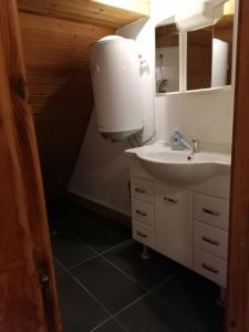 a bathroom with a sink and a water heater at Naab-Wohn in Nabburg