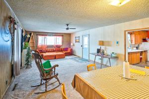 a living room with a table and a couch at Charming Corral Creek Ranch House in Circle in Circle