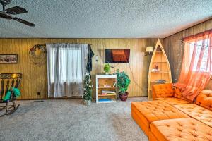 a living room with an orange couch and a window at Charming Corral Creek Ranch House in Circle in Circle
