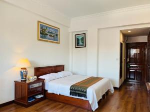 מיטה או מיטות בחדר ב-Chung Hsin Hotel 中信酒店