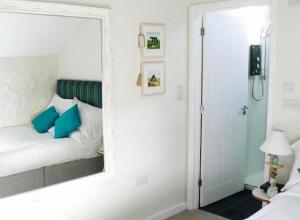 a mirror reflection of a bed in a bedroom at Cape Cornwall Club in St Just
