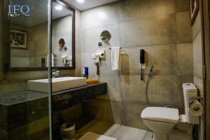 a bathroom with a sink and a toilet and a shower at IFQ Hotel & Resort in Islamabad
