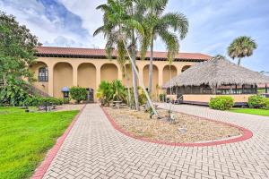 a building with palm trees and a brick walkway at Naples Studio Near Everglades with Marina! in Naples