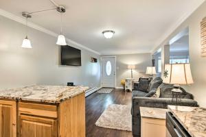 a living room with a couch and a table at Colorado Studio Near the Denver Zoo with Fire Pit! in Lakewood