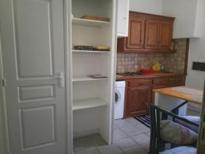 a kitchen with a door open to a kitchen with a stove at Nid douillet in Vals-les-Bains