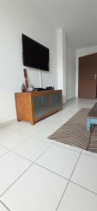 a living room with a flat screen tv on a cabinet at T2 Saint-Denis -Jardin de l'Etat in Saint-Denis
