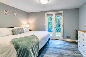 a bedroom with a bed and a glass door at Spacious Rochester Home with Heated Pool and Hot Tub! in Rochester +37 photos