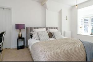 a bedroom with a large bed and a window at Northampton Modern Oasis - Spacious & Stylish in Northampton