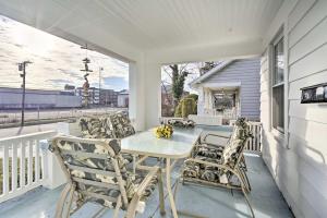a patio with a table and chairs on a balcony at Allenhurst Abode with Porch and Central Location! 