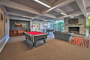 a living room with a ping pong table in front of a fireplace at Deja Blue Beachfront Condo with Resort Pools! in Oceanside