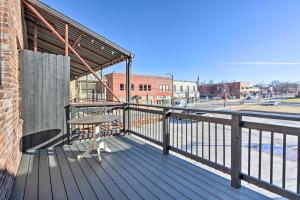 a wooden deck with a bench on a balcony at Upscale Loft in the Heart of Dtwn Springfield in Springfield