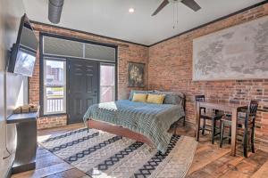 a bedroom with a bed and a brick wall at Upscale Loft in the Heart of Dtwn Springfield in Springfield