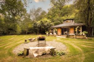 una casa con una hoguera en el patio en Luxury Boltholes cabin in the woods with hot tub, 