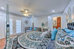 a bedroom with a large bed and a couch at Glam New Orleans Vacation Rental with Deck! in New Orleans