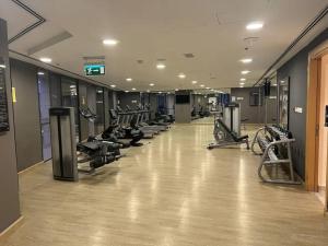 a gym with a row of treadmills and machines at Nice cozy studio in Damac Tower Amman 1104 in Amman