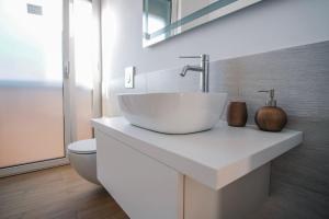 a white bathroom with a sink and a toilet at Rossani Suites&Aparts in Bari +80 photos
