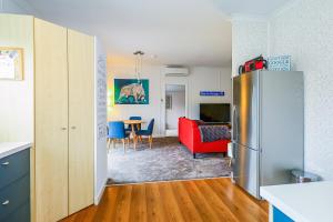 a kitchen and a living room with a refrigerator at Methven Ski Bach With Sleepout in Methven