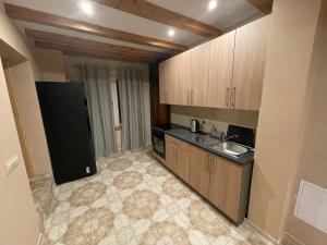 a kitchen with wooden cabinets and a sink in it at Dom Pod Świerkami in Istebna