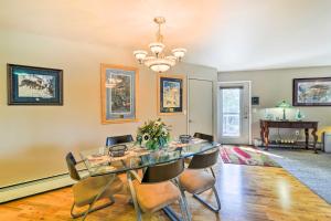 a dining room with a glass table and chairs at Hillside Anchorage Home by Hiking and Biking Trails! in Anchorage