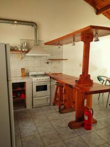 a kitchen with a counter and a stove top oven at Alojamiento Casa en El Bolsón in El Bolsón