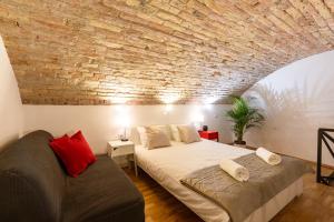 a bedroom with a bed and a brick wall at Modern stylish apartment @ Superb central location in Budapest