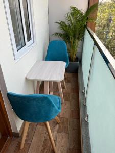 a small table and two chairs on a balcony at NP Royal INN in Bangalore